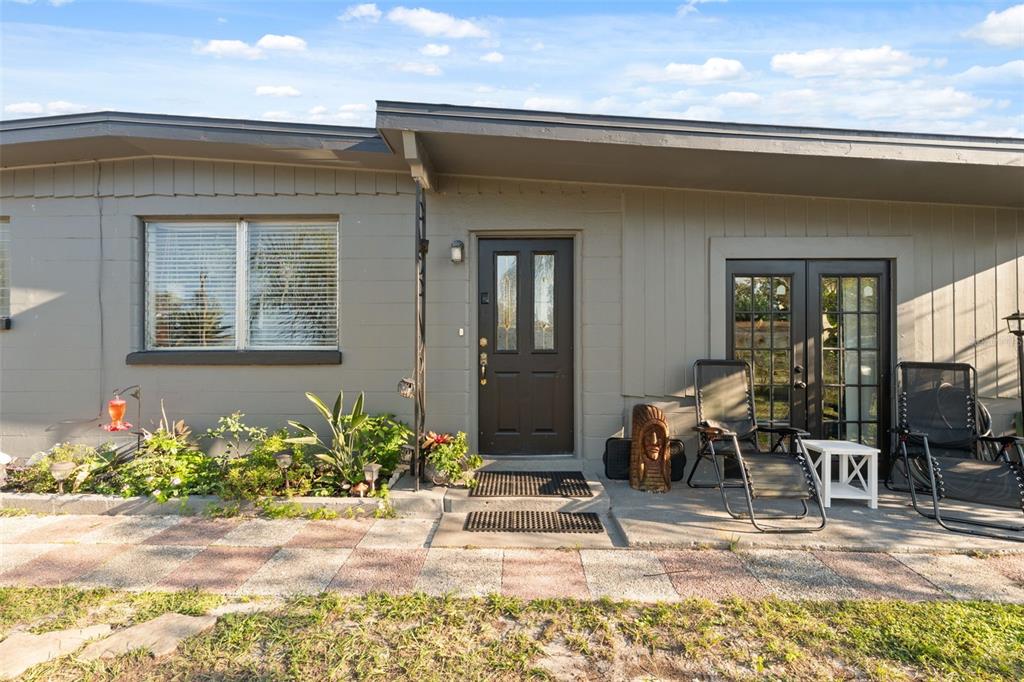 7002 Eisenhower Street Weeki Wachee, FL 34613 - Photo 2 of 65 a front view of a house with outdoor seating