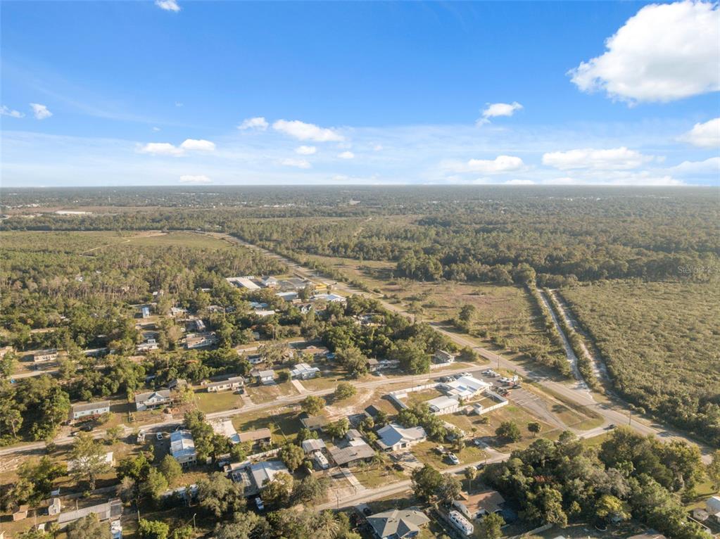 7002 Eisenhower Street Weeki Wachee, FL 34613 - Photo 36 of 65 an aerial view of residential houses with outdoor space and ocean view