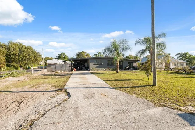 a bedroom with a bed and a flat tv screen on dresser