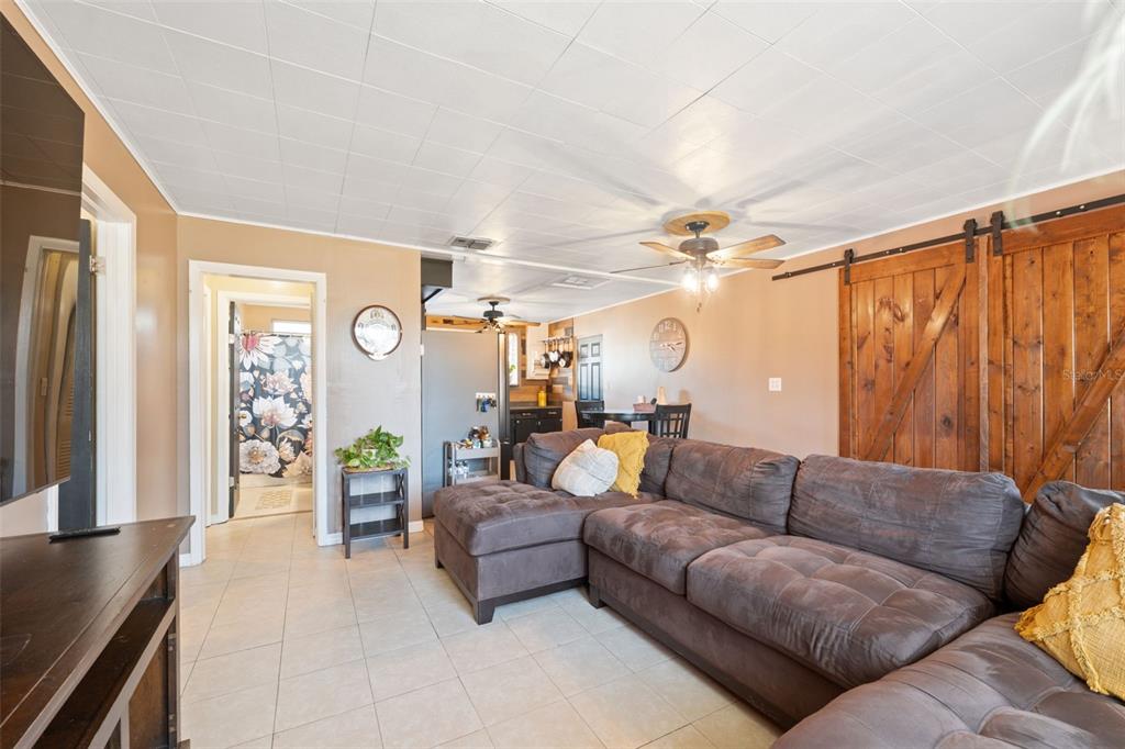 7002 Eisenhower Street Weeki Wachee, FL 34613 - Photo 57 of 65 a living room with furniture and a chandelier