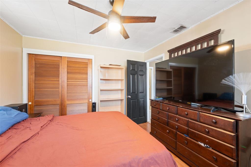 7002 Eisenhower Street Weeki Wachee, FL 34613 - Photo 61 of 65 a bedroom with a bed and a flat tv screen on dresser