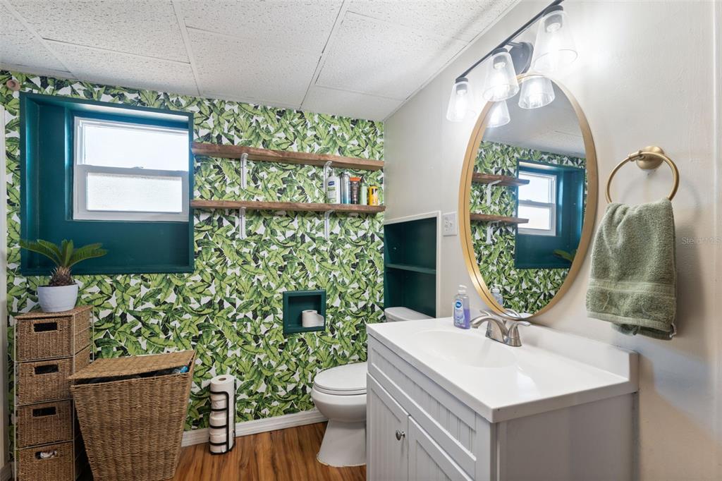 7002 Eisenhower Street Weeki Wachee, FL 34613 - Photo 8 of 65 a bathroom with a toilet sink and mirror