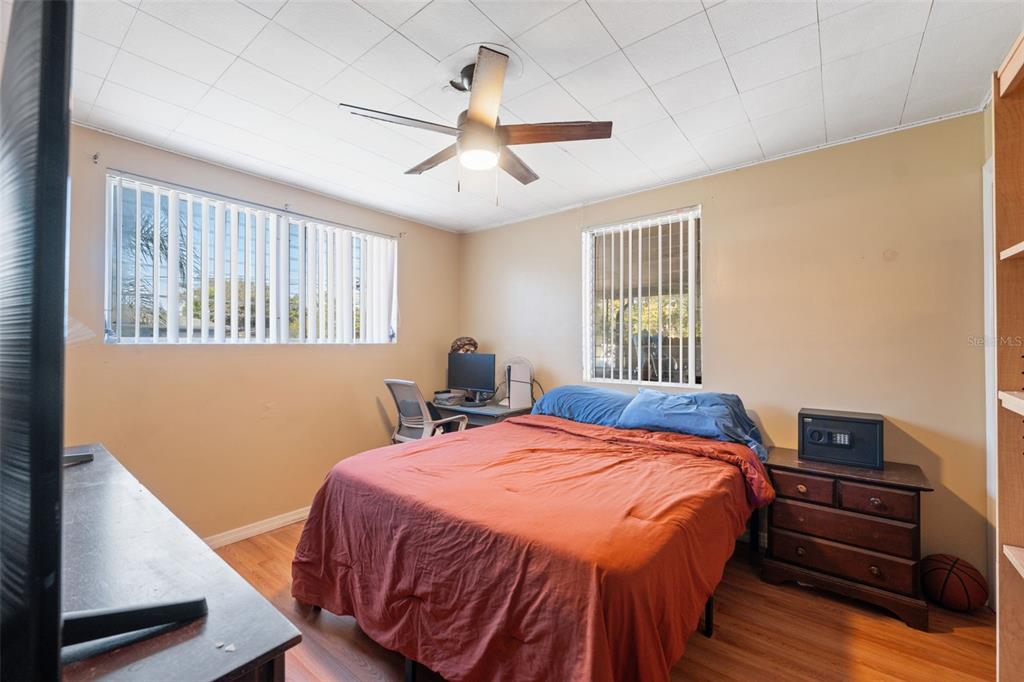 7002 Eisenhower Street Weeki Wachee, FL 34613 - Photo 9 of 65 a bed sitting in a bedroom next to a window