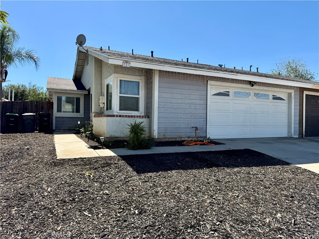 321 Red Cedar Place Perris, CA 92570 - Photo 1 of 21 a front view of a house with a yard