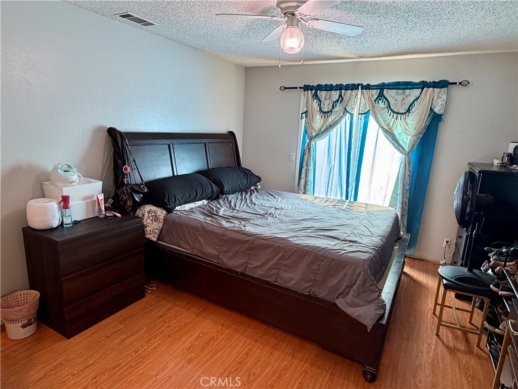 321 Red Cedar Place Perris, CA 92570 - Photo 13 of 21 a bedroom with a bed window and a mirror
