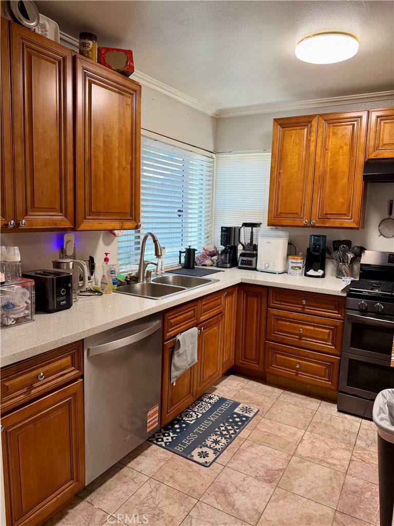 321 Red Cedar Place Perris, CA 92570 - Photo 6 of 21 a kitchen with a sink stove and cabinets