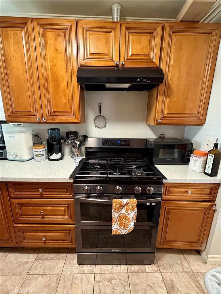 321 Red Cedar Place Perris, CA 92570 - Photo 8 of 21 a kitchen with a stove and a window
