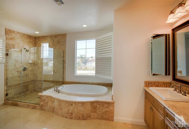 4057 West Hemlock Street Oxnard, CA 93035 - Photo 11 of 11 a bathroom with a tub sink and mirror