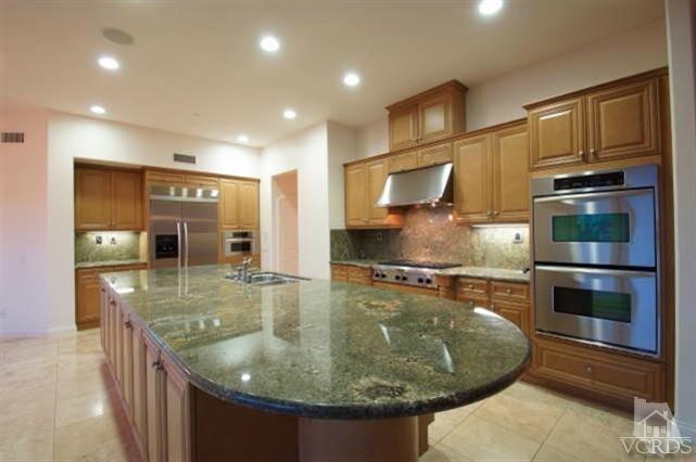 4057 West Hemlock Street Oxnard, CA 93035 - Photo 4 of 11 a kitchen with stainless steel appliances granite countertop a sink and cabinets