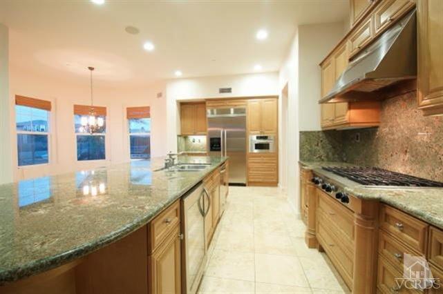 4057 West Hemlock Street Oxnard, CA 93035 - Photo 6 of 11 a large kitchen with stainless steel appliances granite countertop a sink and cabinets