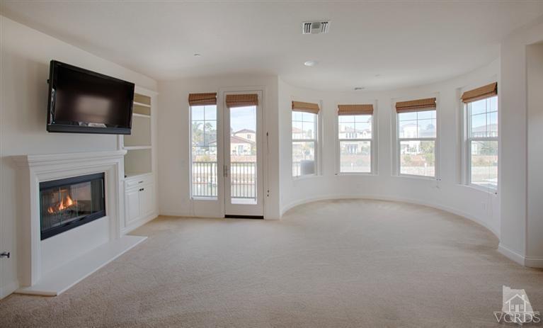 4057 West Hemlock Street Oxnard, CA 93035 - Photo 8 of 11 a view of an empty room with furniture and a fireplace