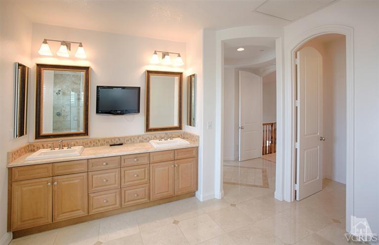 4057 West Hemlock Street Oxnard, CA 93035 - Photo 10 of 11 a spacious bathroom with a double vanity sink and mirror