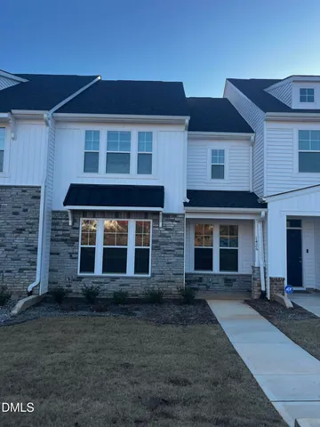 a view of a brick house with many windows