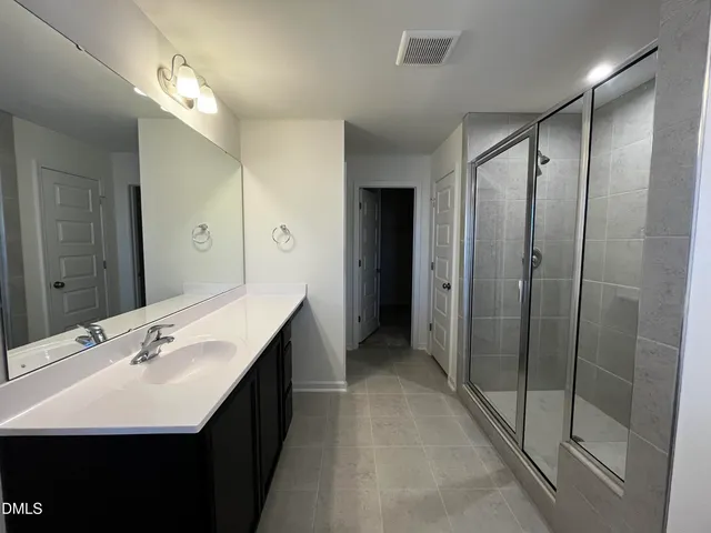a bathroom with a double vanity sink a and mirror