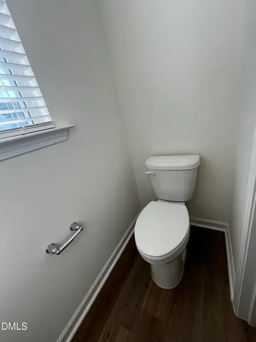 a bathroom with a toilet and a window