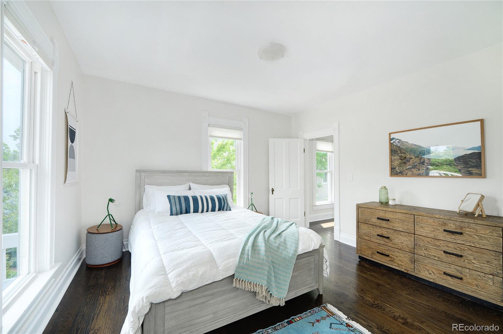 2040 Walnut Street Boulder, CO 80302 - Photo 25 of 40 a bedroom with a bed and wooden floor