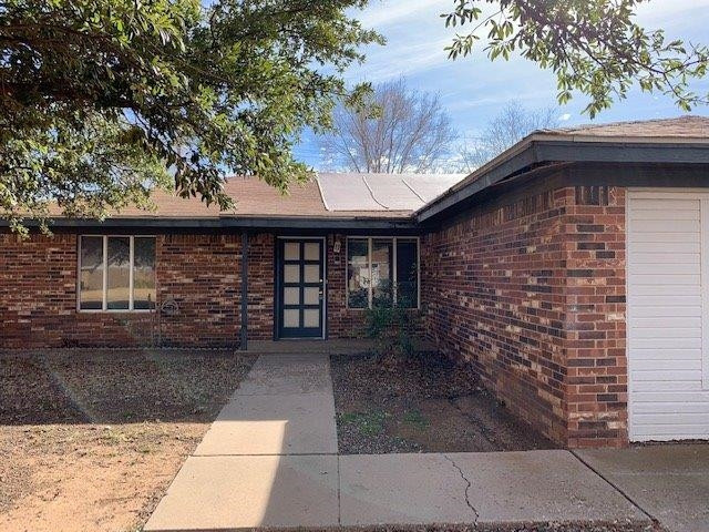 4819 73rd Street Lubbock, TX 79424 - Photo 1 of 7 a front view of a house with garden