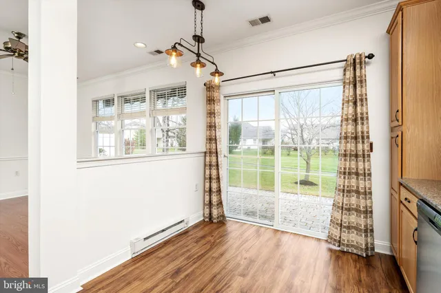 a view of a room with wooden floor and windows