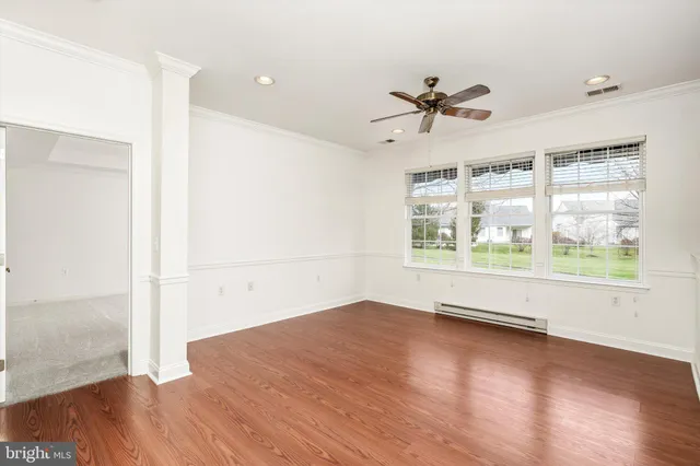 wooden floor in an empty room with a window