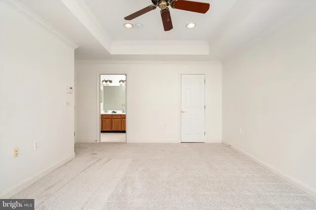 a view of an empty walk in closet with wooden floor