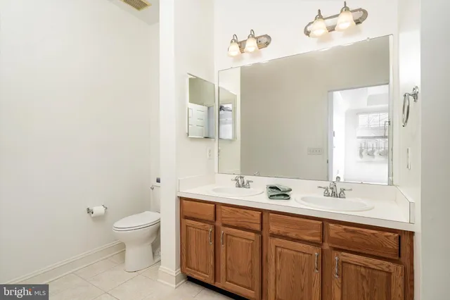a bathroom with a shower sink vanity and mirror