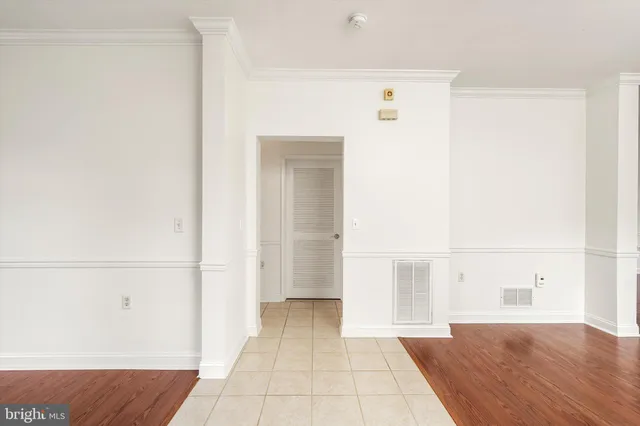 a view of a bedroom with wooden floor and cabinet