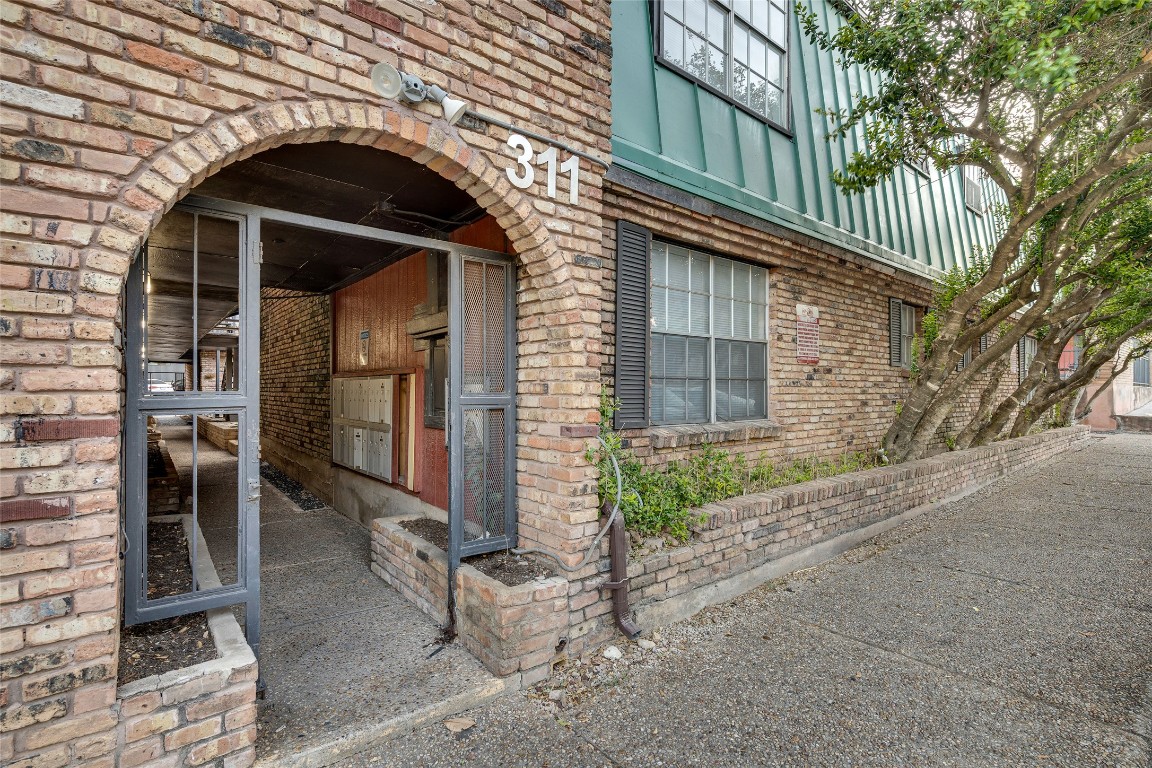 311 East 31st Street, Unit 103 Austin, TX 78705 - Photo 1 of 27 a view of a house with a door and a large tree