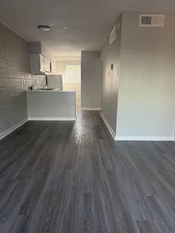 a view of a kitchen with wooden floor and a sink