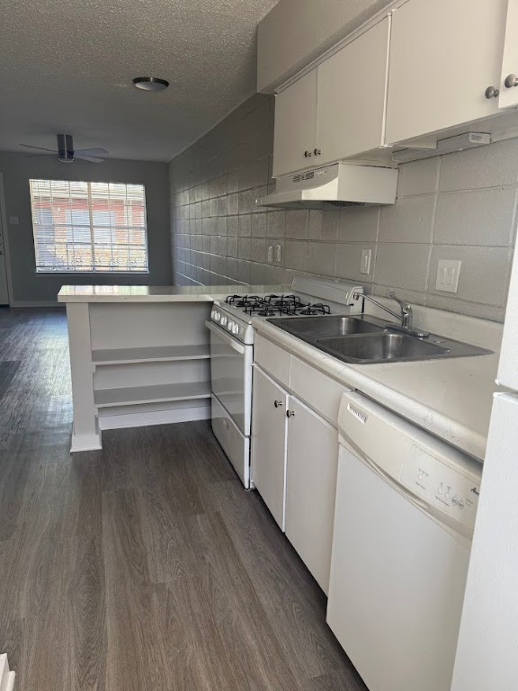 311 East 31st Street, Unit 103 Austin, TX 78705 - Photo 9 of 27 a kitchen with granite countertop white cabinets and white appliances