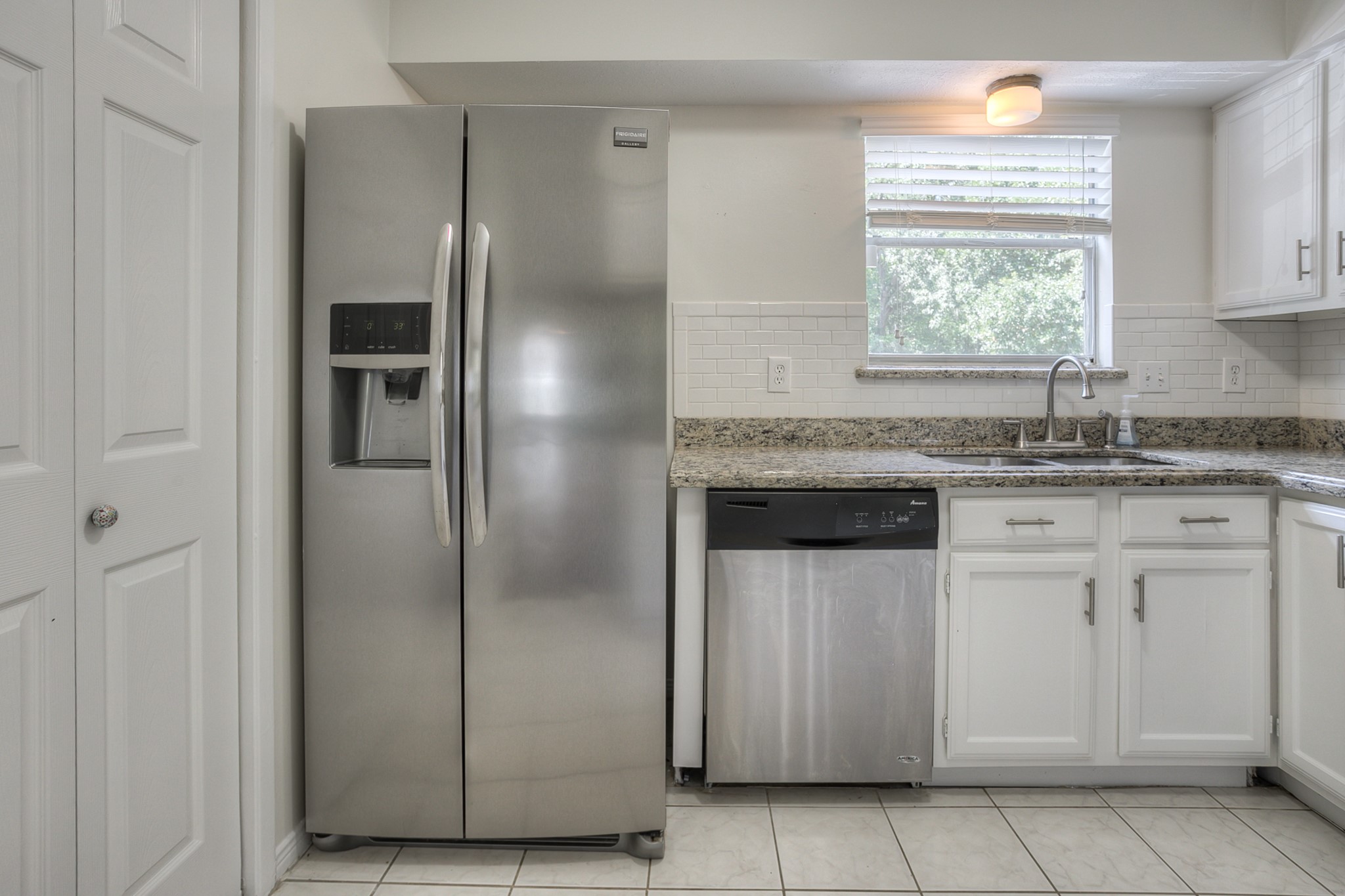 287 Broadmoor Street Trinity, TX 75862 - Photo 15 of 36 a kitchen with stainless steel appliances granite countertop a sink and a refrigerator