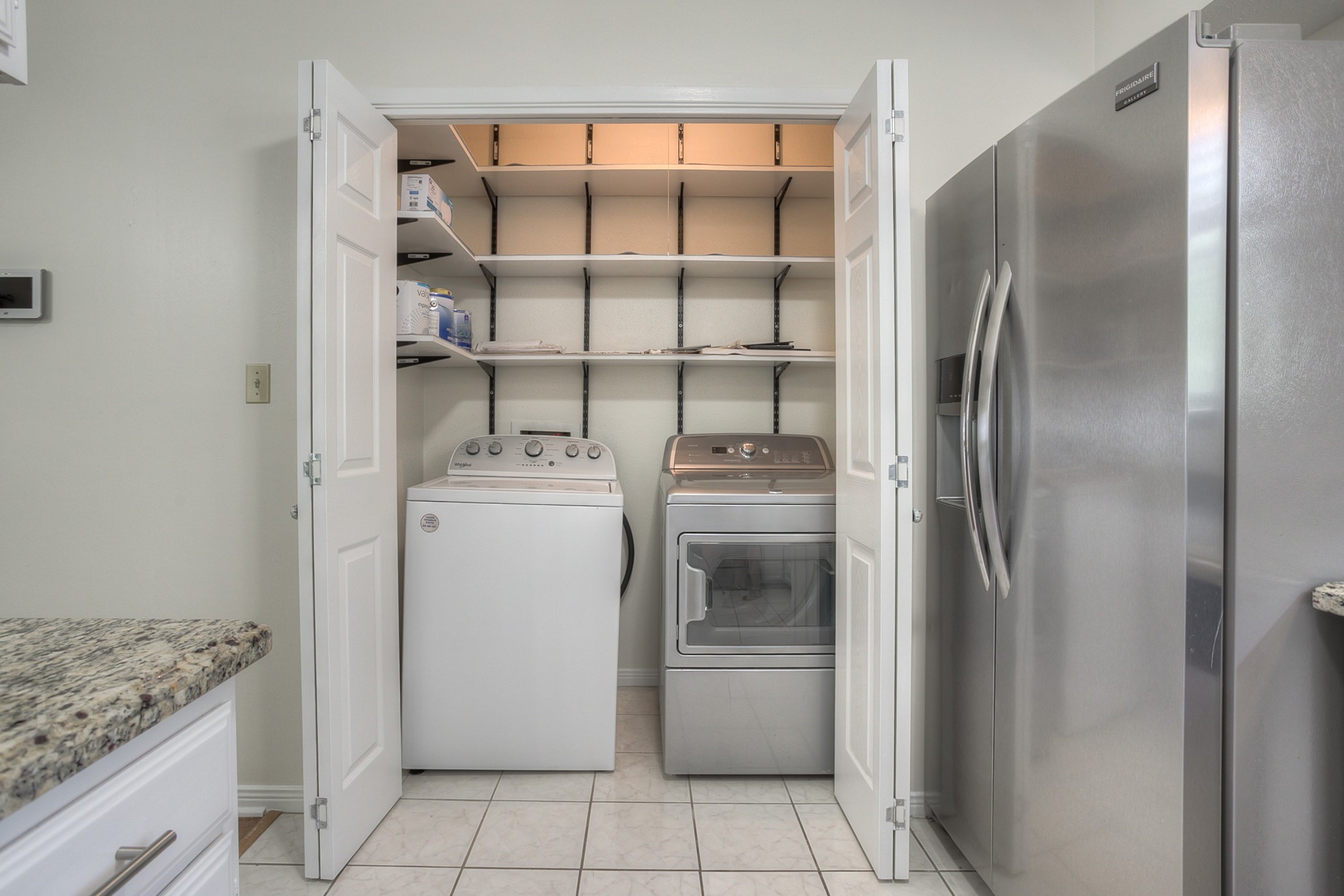 287 Broadmoor Street Trinity, TX 75862 - Photo 16 of 36 a utility room with cabinets washer and dryer