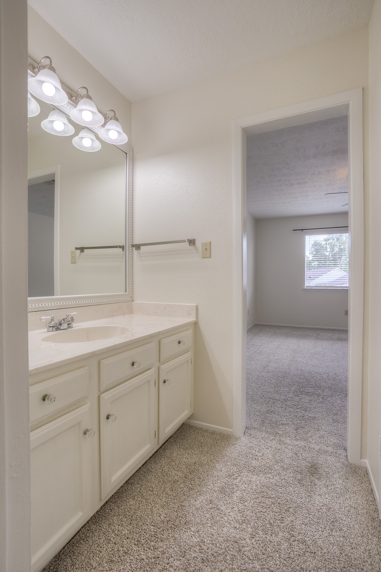 287 Broadmoor Street Trinity, TX 75862 - Photo 21 of 36 a spacious bathroom with a granite countertop sink a large mirror and vanity