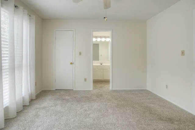 an empty room with an entryway and a window