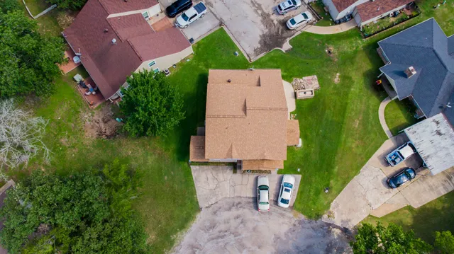 an aerial view of a house with a yard