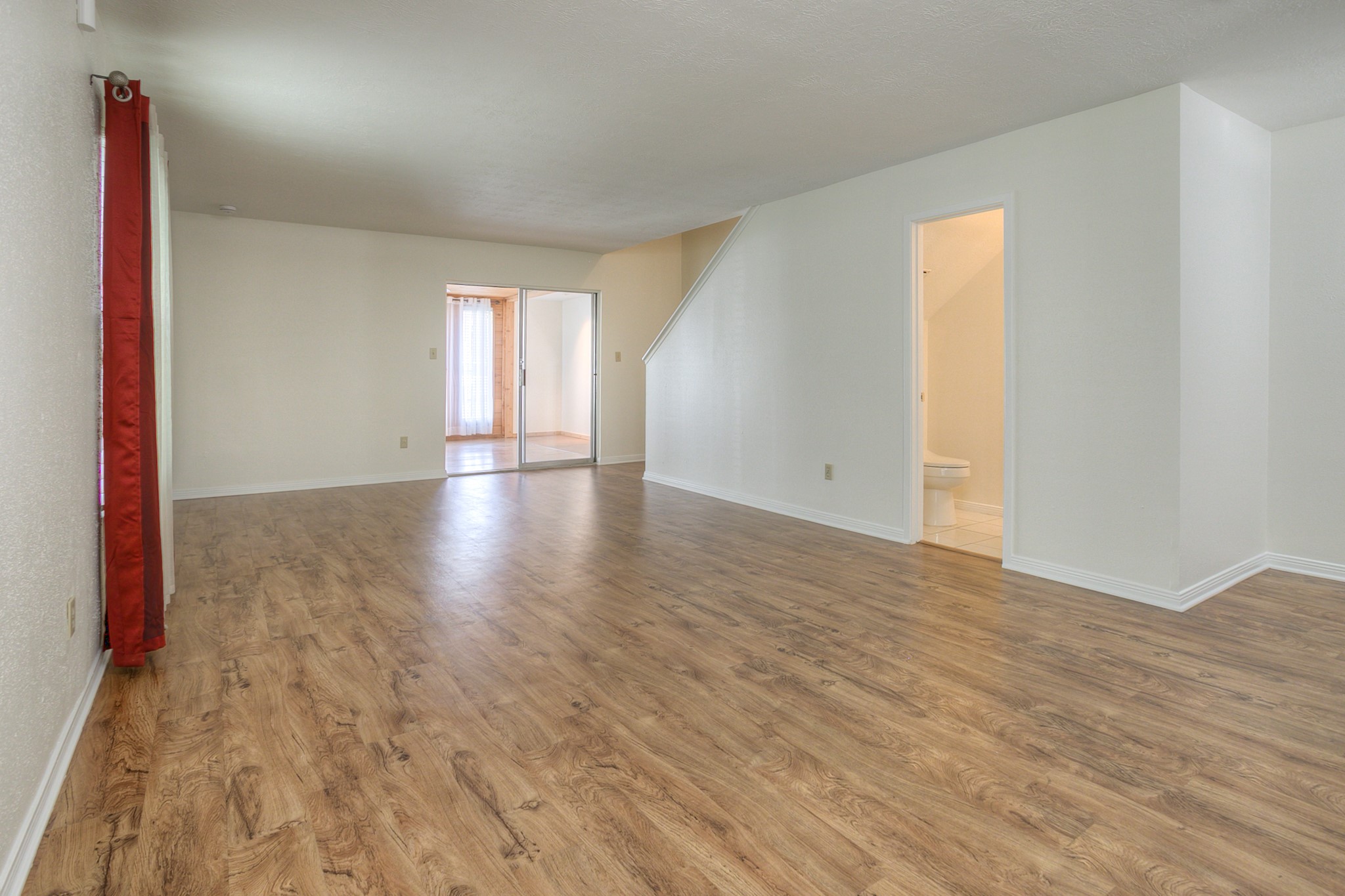 287 Broadmoor Street Trinity, TX 75862 - Photo 7 of 36 an empty room with wooden floor and windows