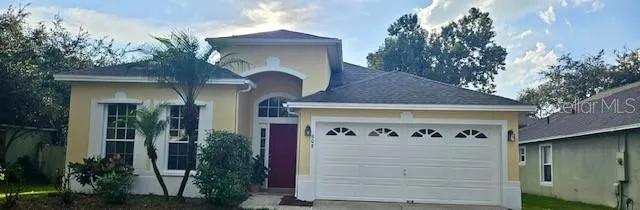 a front view of a house with plants
