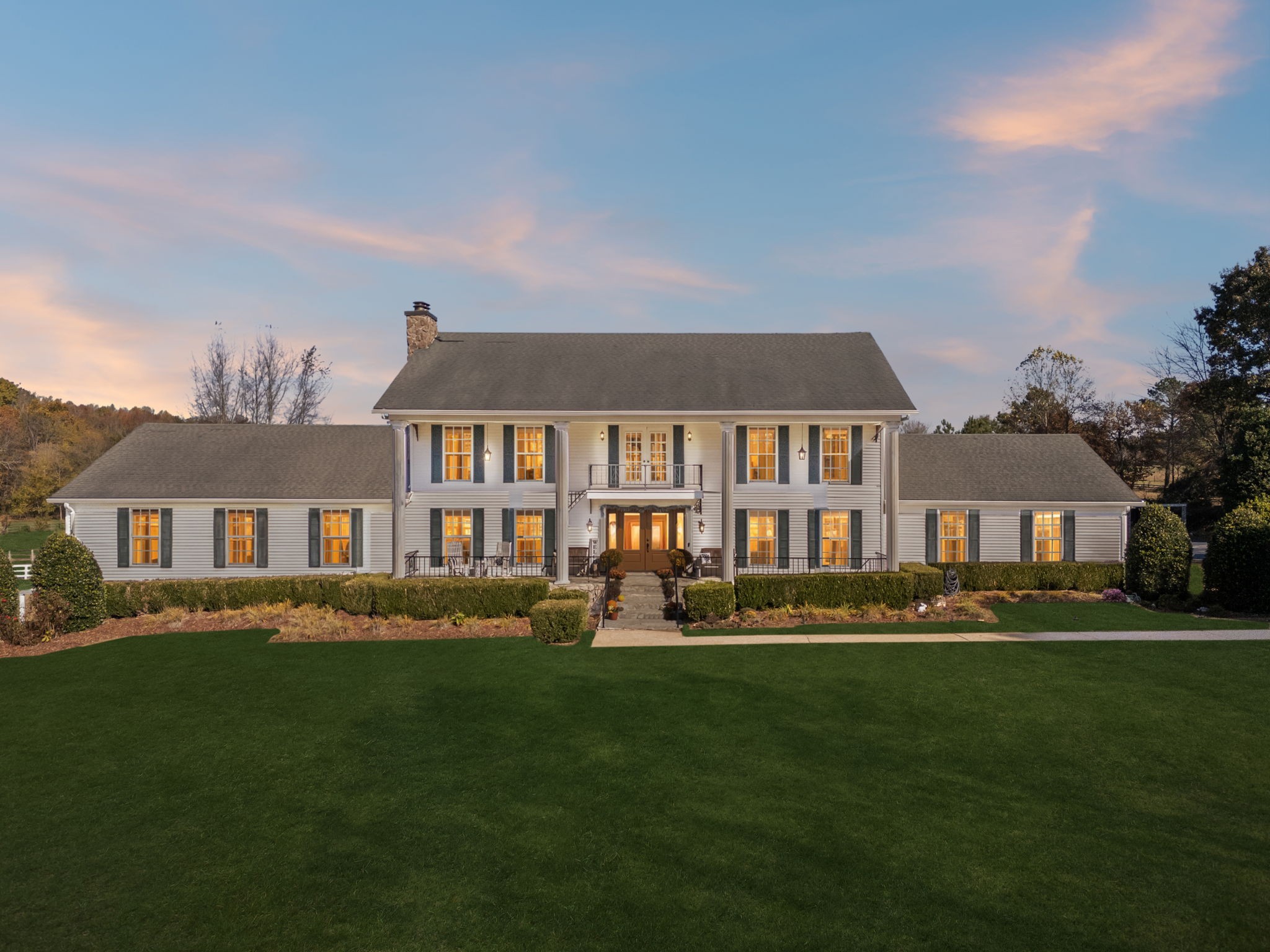 a front view of a house with a garden