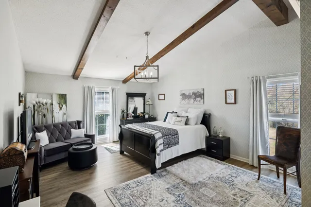 a room with lots of wooden furniture and a view of bedroom