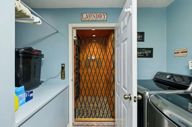 a kitchen with stainless steel appliances granite countertop a refrigerator a sink dishwasher a stove and white countertops with wooden floor