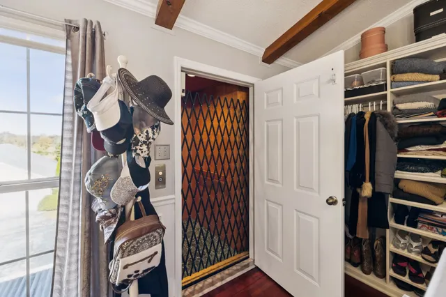 a view of a balcony with floor to ceiling windows and wooden fence