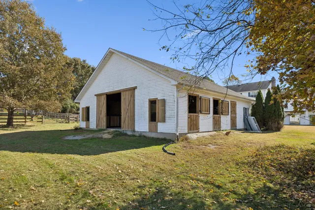 a view of a house with a yard and potted plants