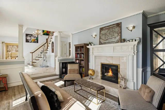 a living room with furniture a fireplace and a flat screen tv