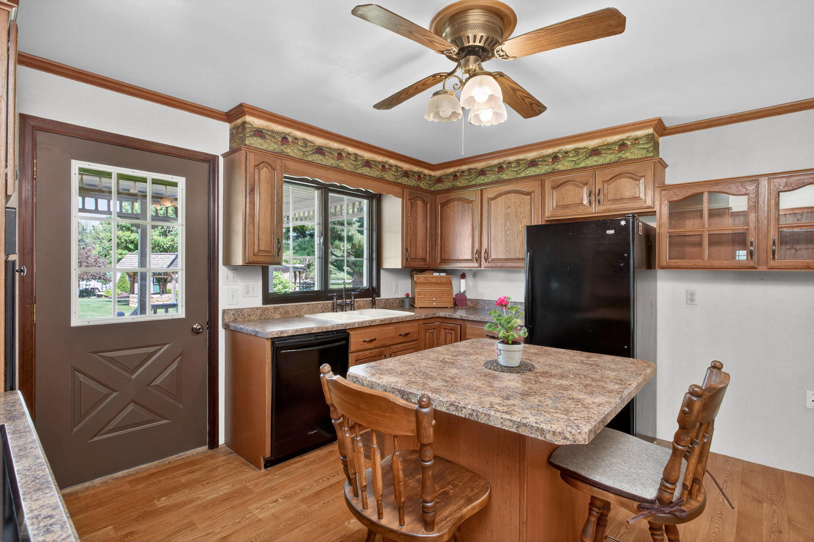 2660 252nd Street De Witt, IA 52742 - Photo 17 of 45 a kitchen with a table chairs and refrigerator