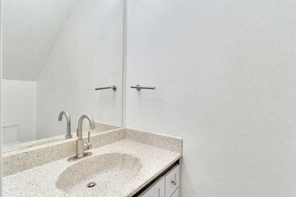 a bathroom with a sink and vanity