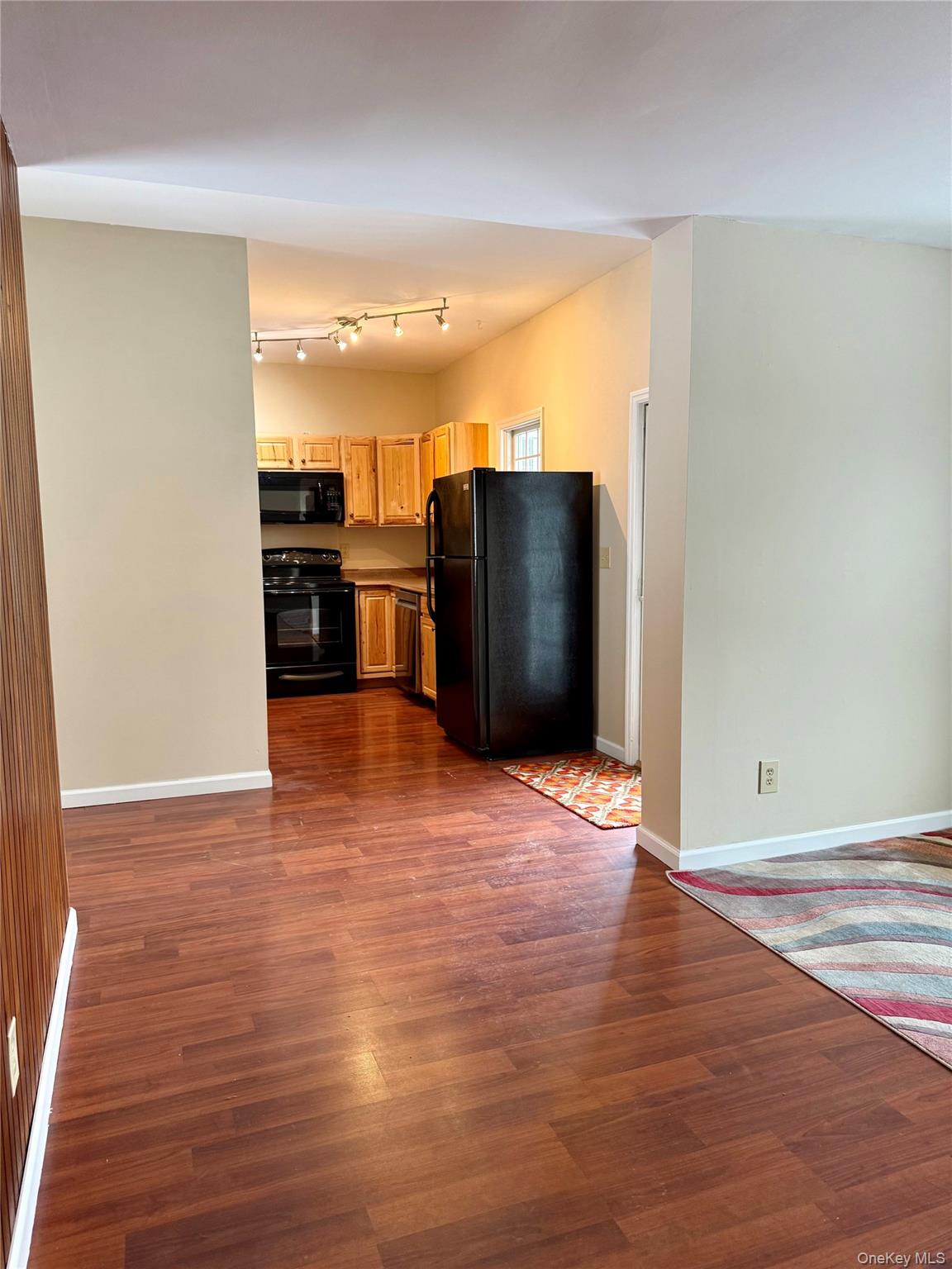 91-97 Sawmill Road Red Hook, NY 12571 - Photo 8 of 8 Kitchen featuring black appliances, dark wood-style flooring, and open floor plan