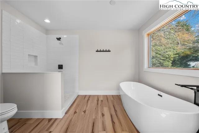 a bathroom with a bathtub and toilet