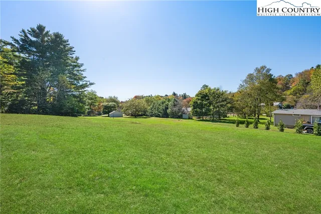 a view of a field of grass and trees