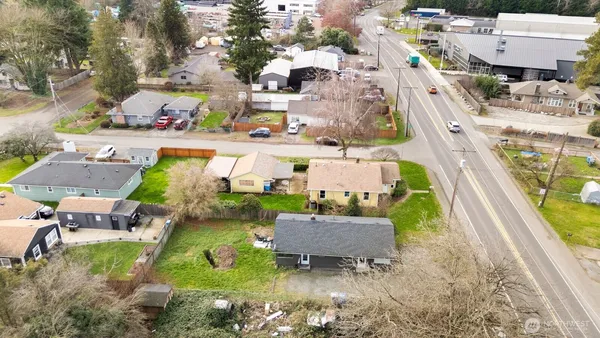 a aerial view of a house with swimming pool and large trees