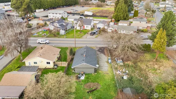 an aerial view of a house with a yard and garden