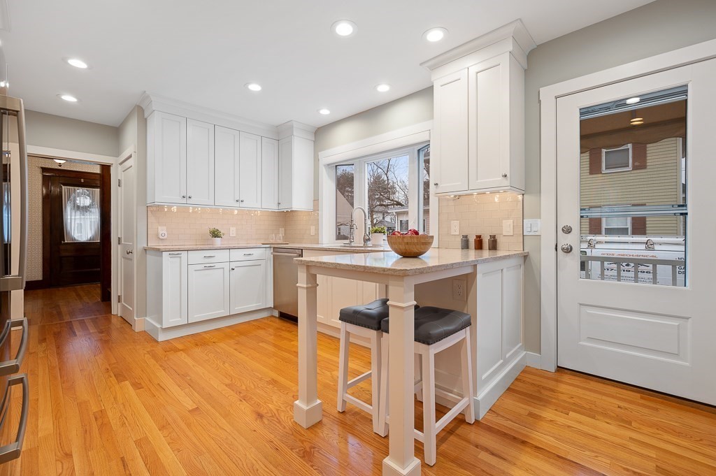 17 George Street Framingham, MA 01702 - Photo 11 of 38 a kitchen with a sink cabinets and wooden floor